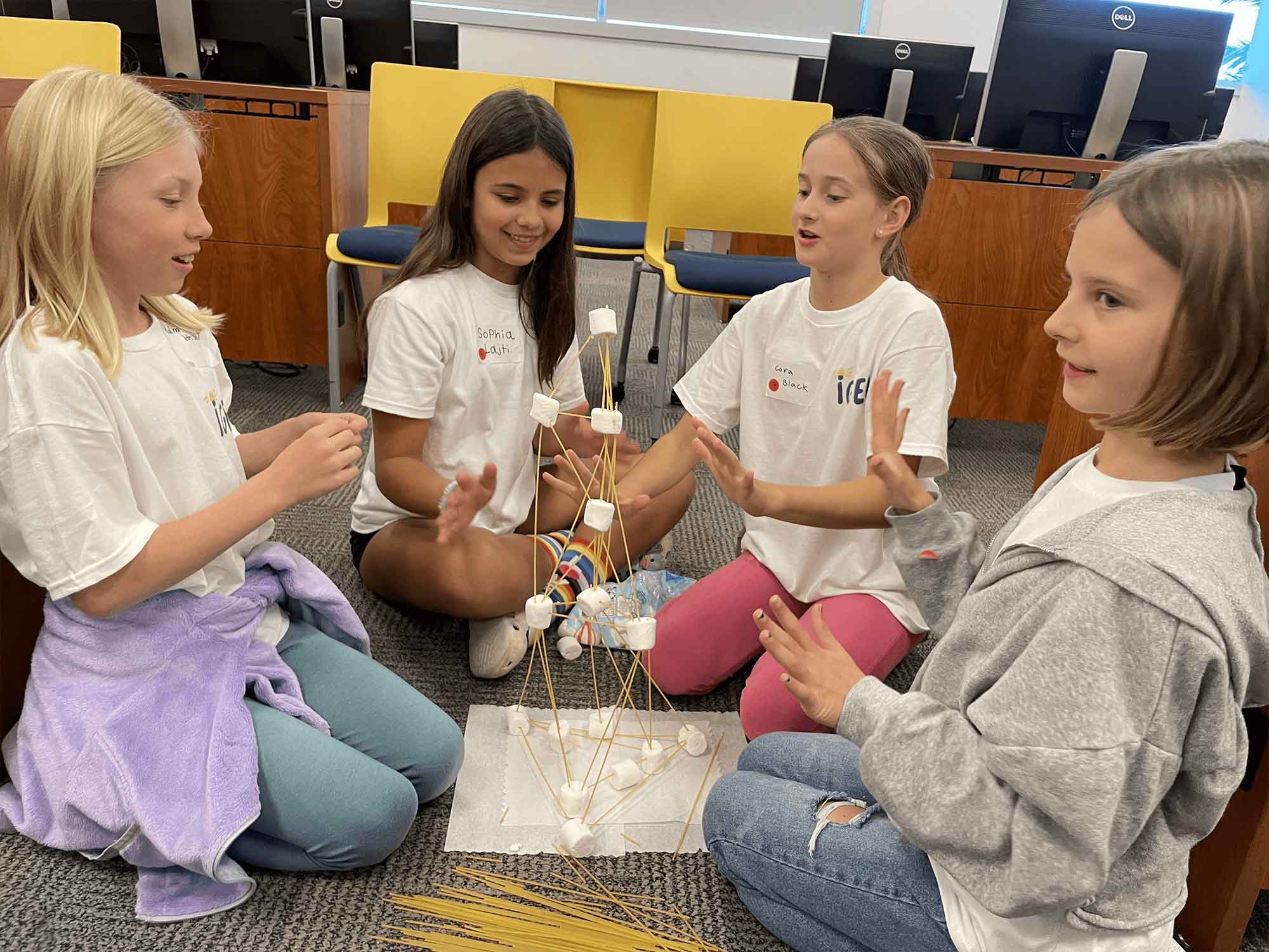 Four students from Volusia County get a lesson in Civil Engineering by building a tower out of spaghetti and marshmallows. (Photo: Embry‑Riddle)