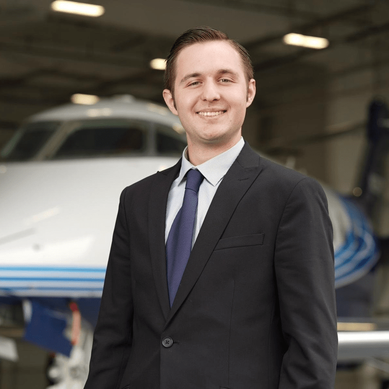 Timothy Gelfer, shown here wearing a business suit in front of a corporate jet, worked as an intern with the National Business Aviation Association. (Photo: Timothy Gelfer)