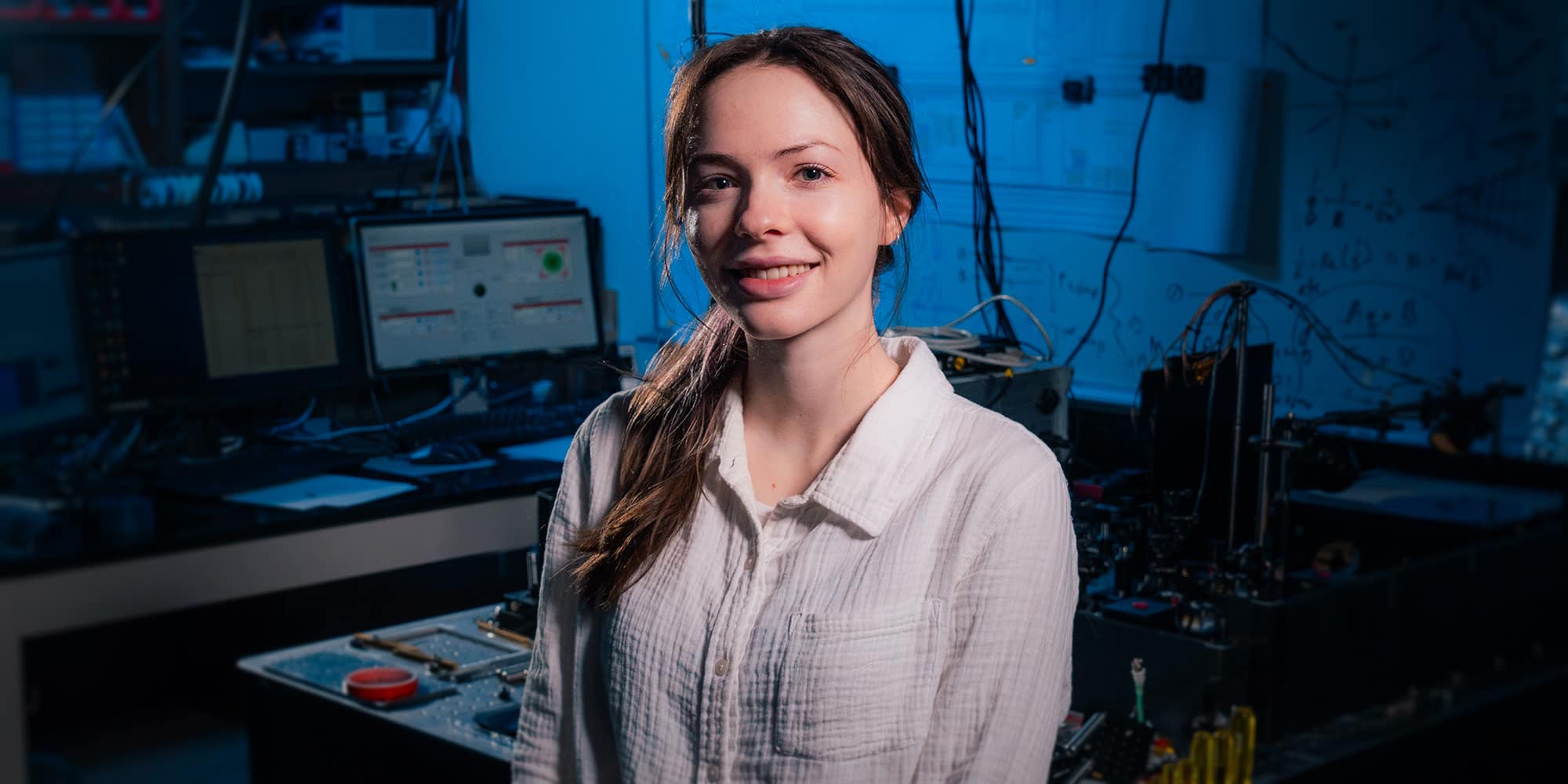 Hailey Murray standing inside the EagleSat Lab, a research and design lab for the EagleSat space grant project.