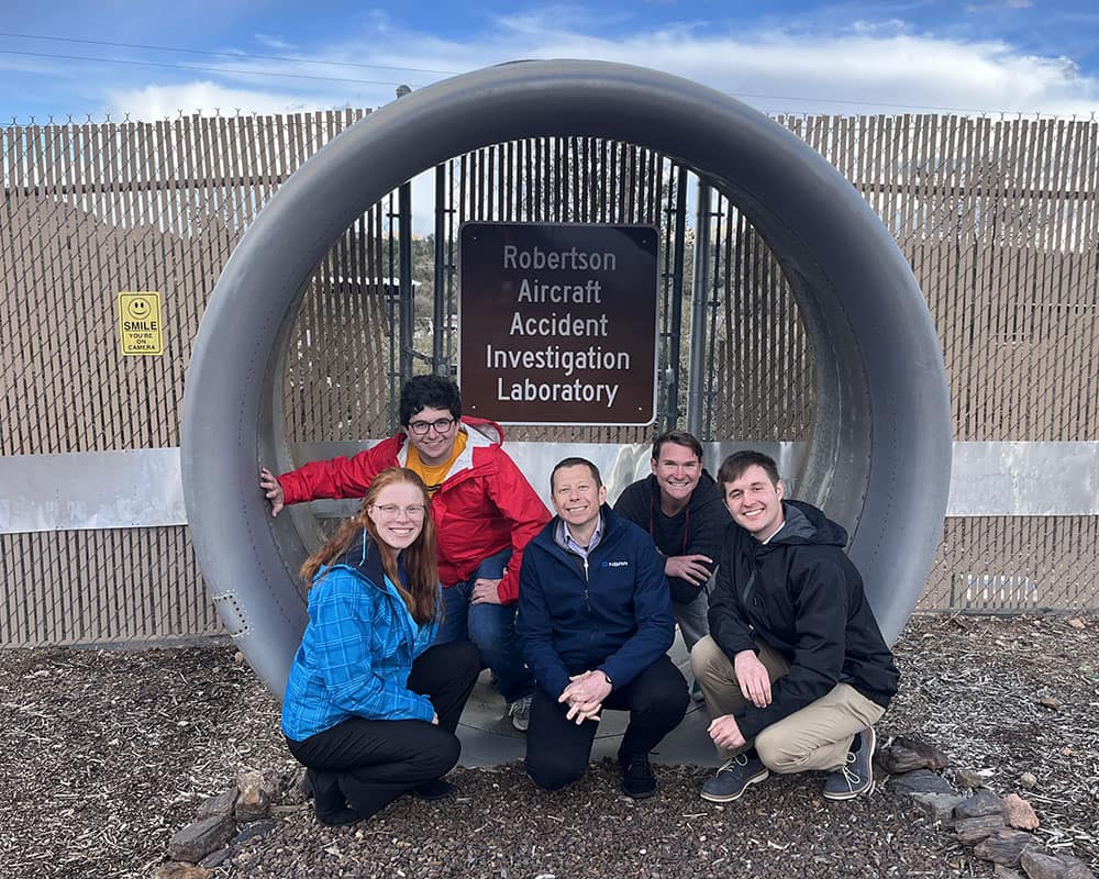 Alex Gertsen of the NBAA (center) visits the Crash Lab at the Prescott Campus with AAAE Chapter President Margaret Colwell (left) and members Aidan McGlasson, Christopher Iammarino and Timothy Gelfer (left to right). (Photo: AAAE Prescott Chapter)