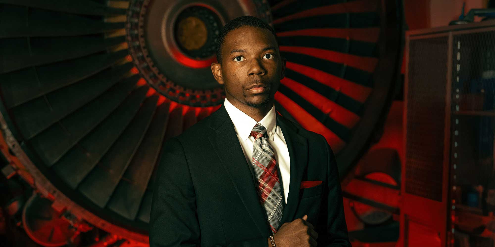 Benjamin Carter with a turbine on campus.