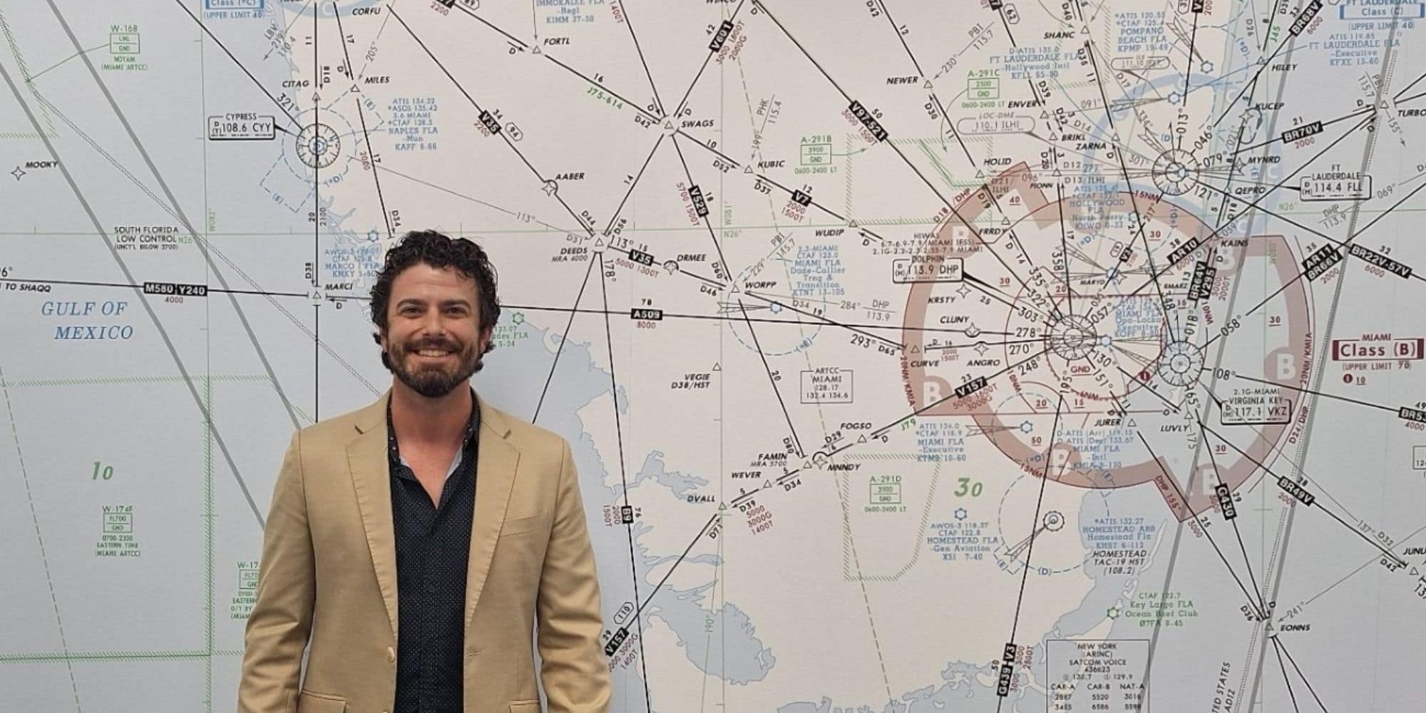 JJ Everett standing in front of sectional aeronautical chart with airways, waypoints, and controlled airspace markings.