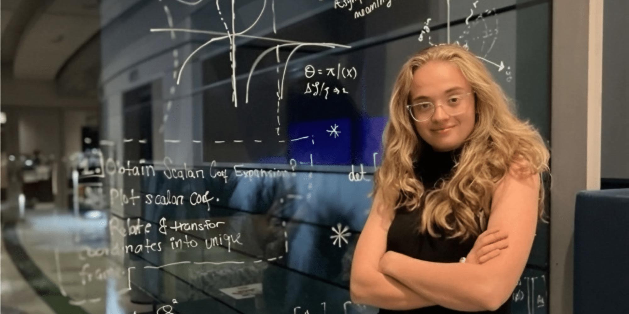 Newell in front of a blackboard.
