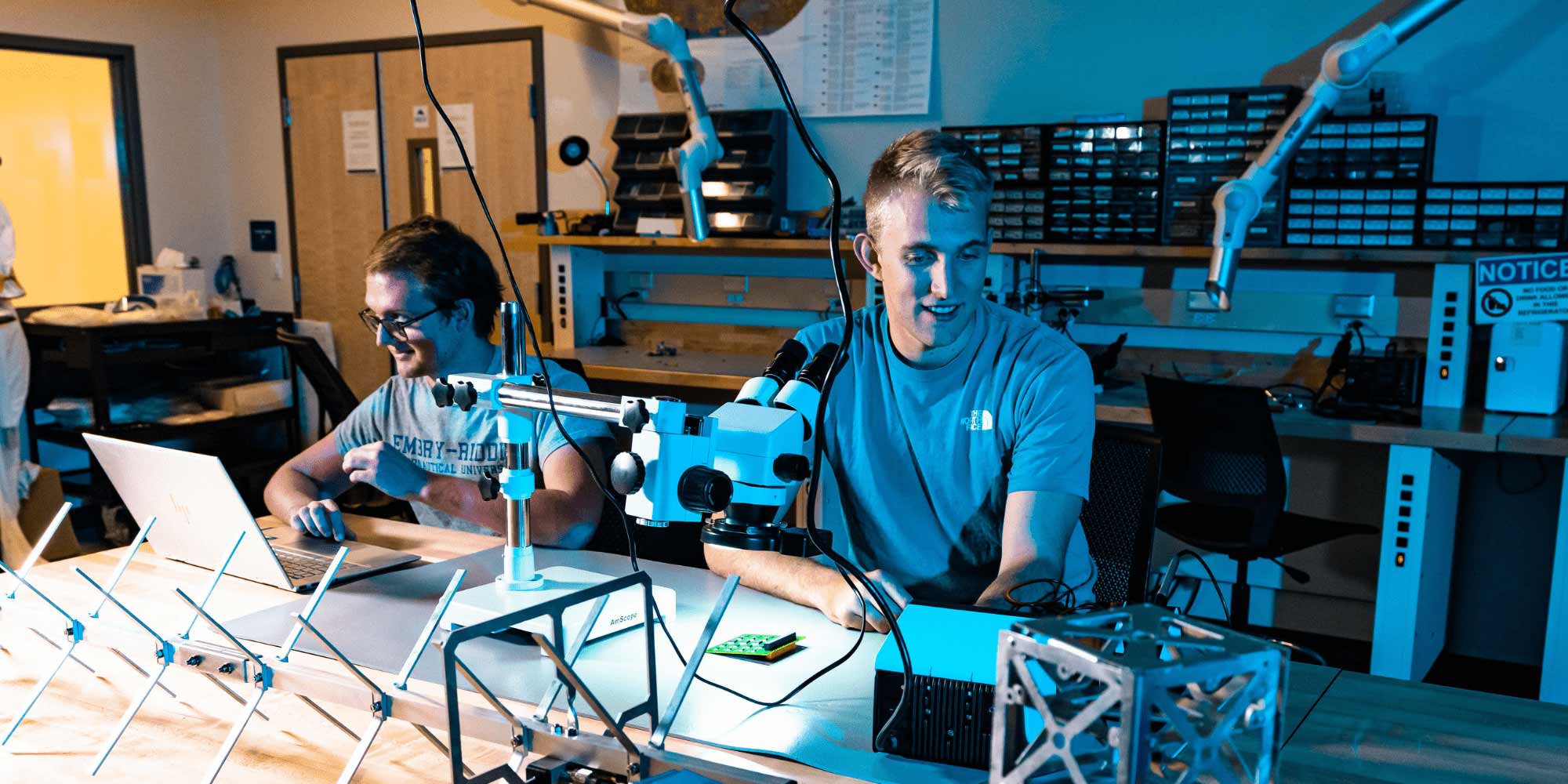 Hayden West (project manager) and Joshua Parmenter (onboard computer lead) at work in the EagleSat Lab. (Photo: Connor McShane)