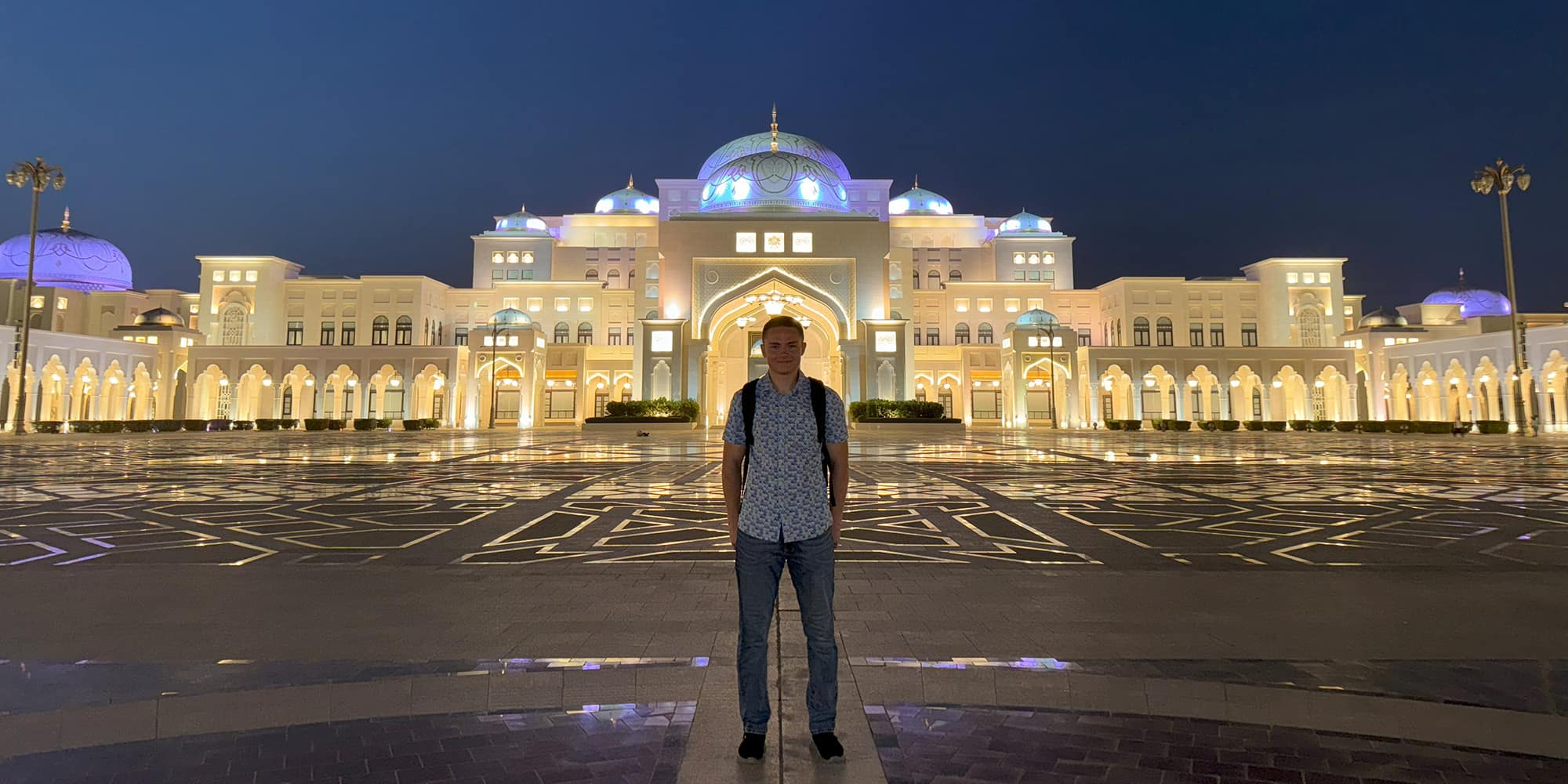 EJ in front of the Qasr Al Watan presidential palace. (Photo: EJ Bailey)