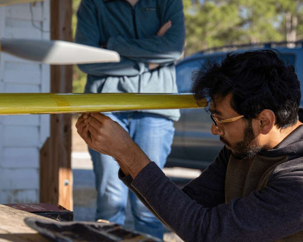 Vikas Patel working on the aircraft that his team won second place for in the 2022 Design, Build, Fly competition. 