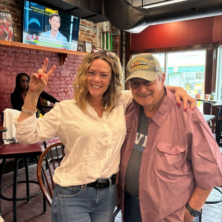 Carrie Merlin alongside her father, Larry T. Anderson.