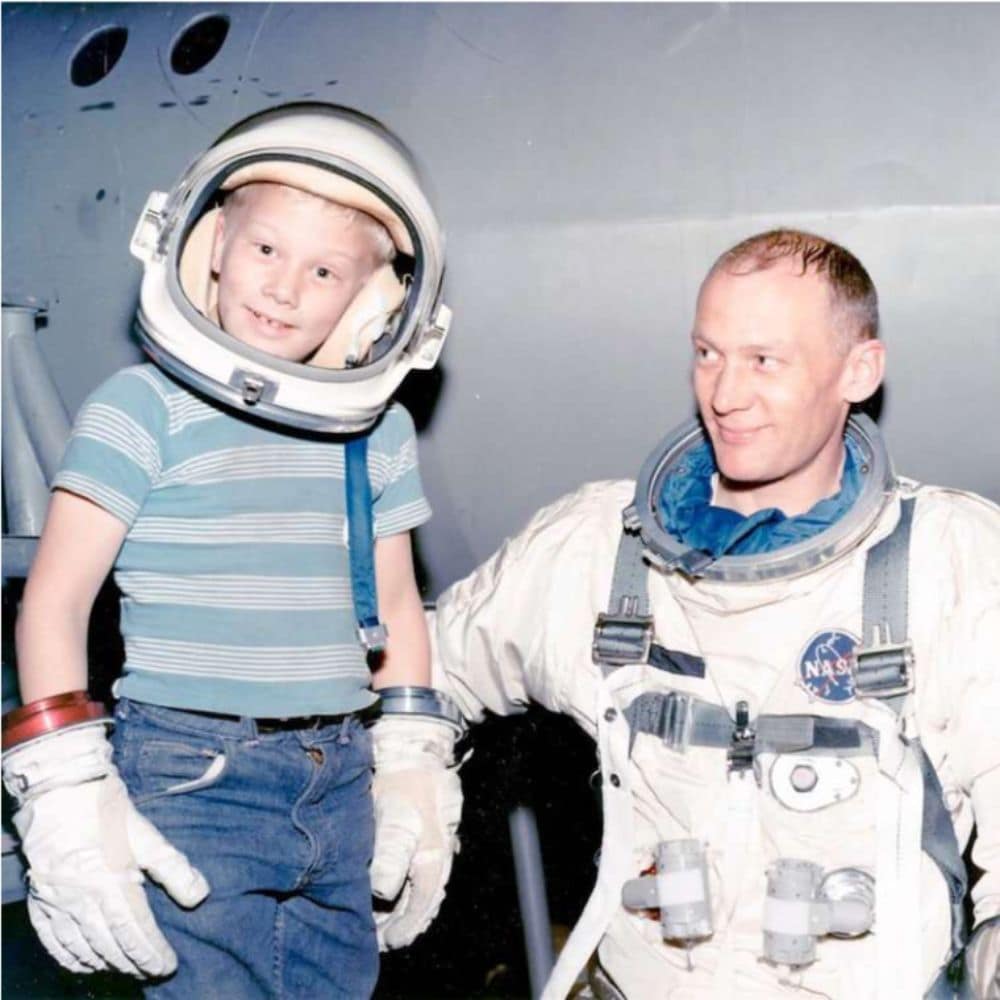 Dr. Andy Aldrin wearing his father, Buzz Aldrin's, astronaut helmet and gloves.