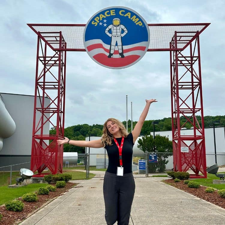 Gwynlyn Hannah stands in front of entrance of NASA Space Camp in Huntsville.