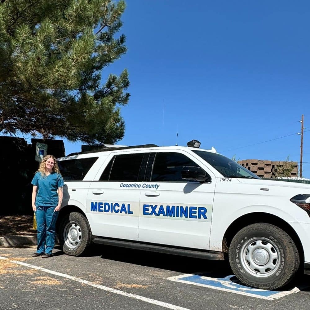 Peyton Adley stands beside the Medical Examiner vehicle used for responding to death scenes during her internship. (Photo: Peyton Adley)