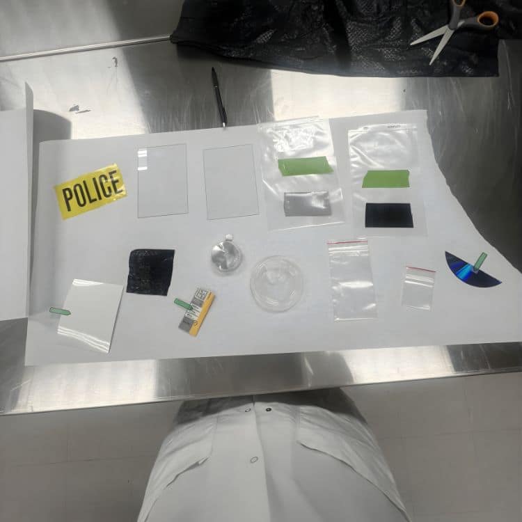 Several forensic evidence samples are arranged for testing in the Lumicyano project, used to develop latent fingerprints.