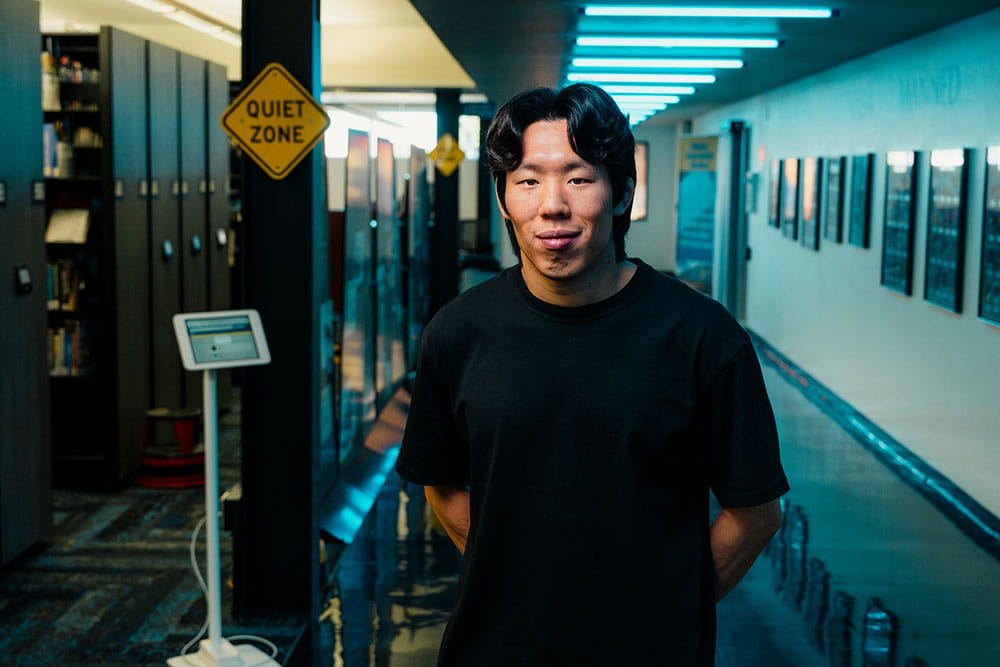 Chang Hun stands in the Hazy Library and Learning Center