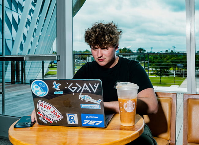Drew Blessit studying in front of a laptop
