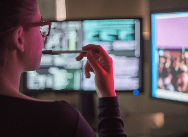 A woman looking at computer screens