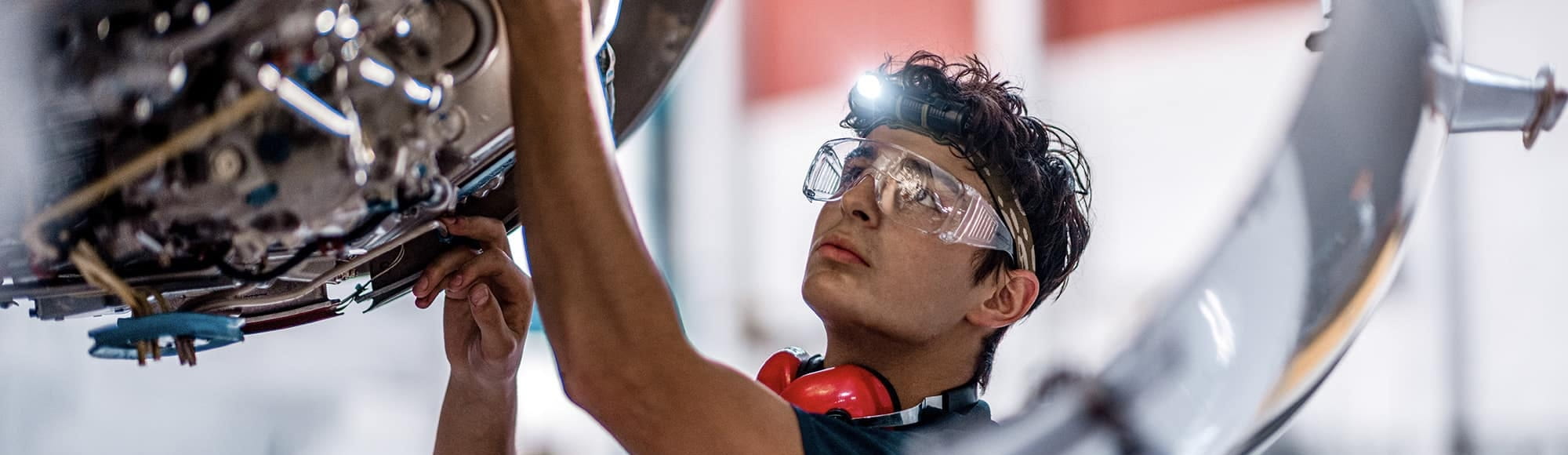 An Embry-Riddle student works on an aircraft engine. 