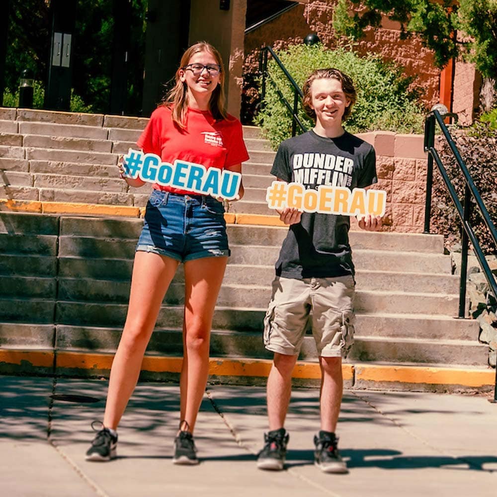 Embry-Riddle students hold #goERAU signs outside