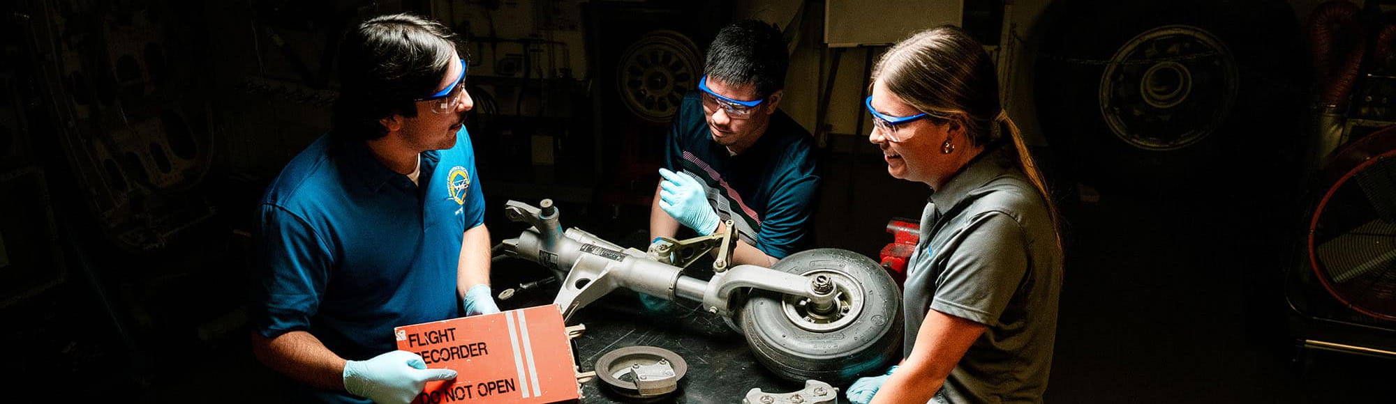 Embry-Riddle students work on a plane wheel in the mechanics lab