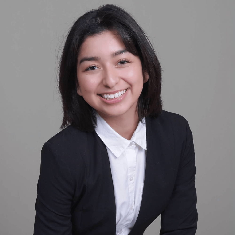 lauren estrada sits for a professional headshot in professional dress