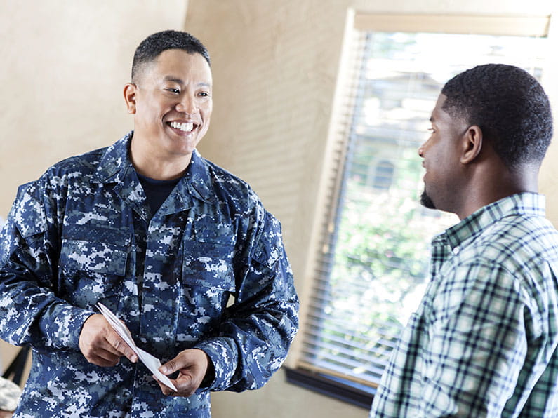 Navy member works with a community member on paperwork