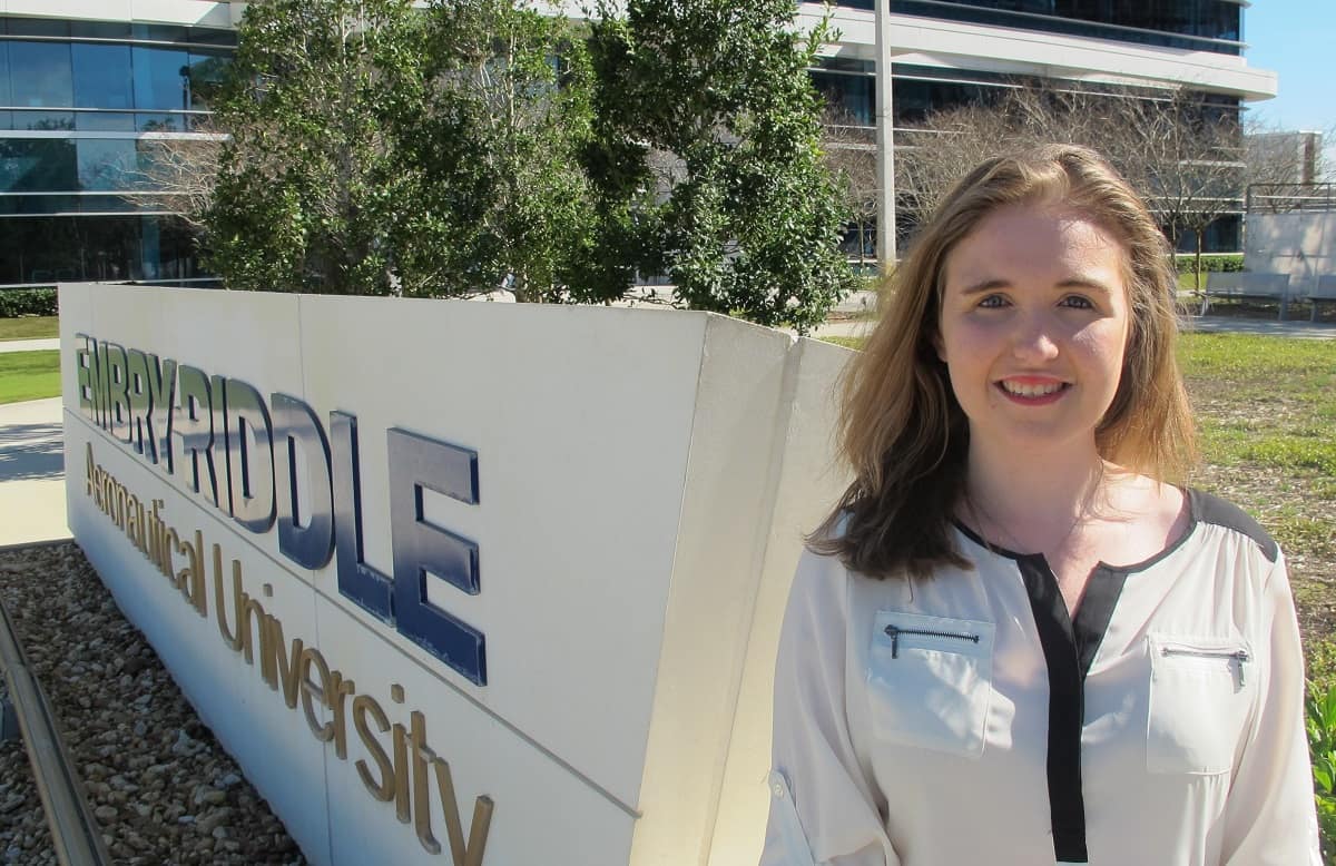 Woman poses in front of Embry-Riddle sign.