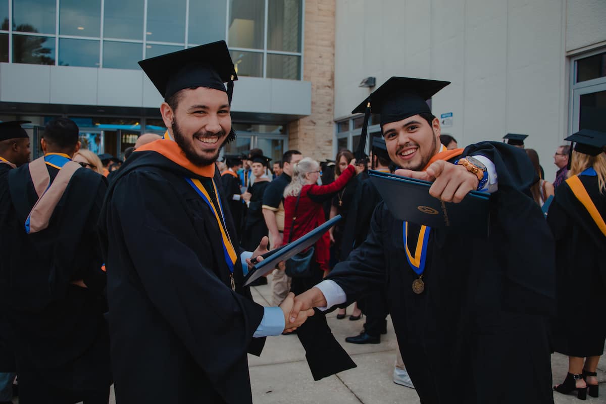Embry-Riddle students shake hands after graduating