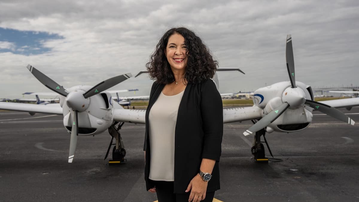 woman stands in front of planes