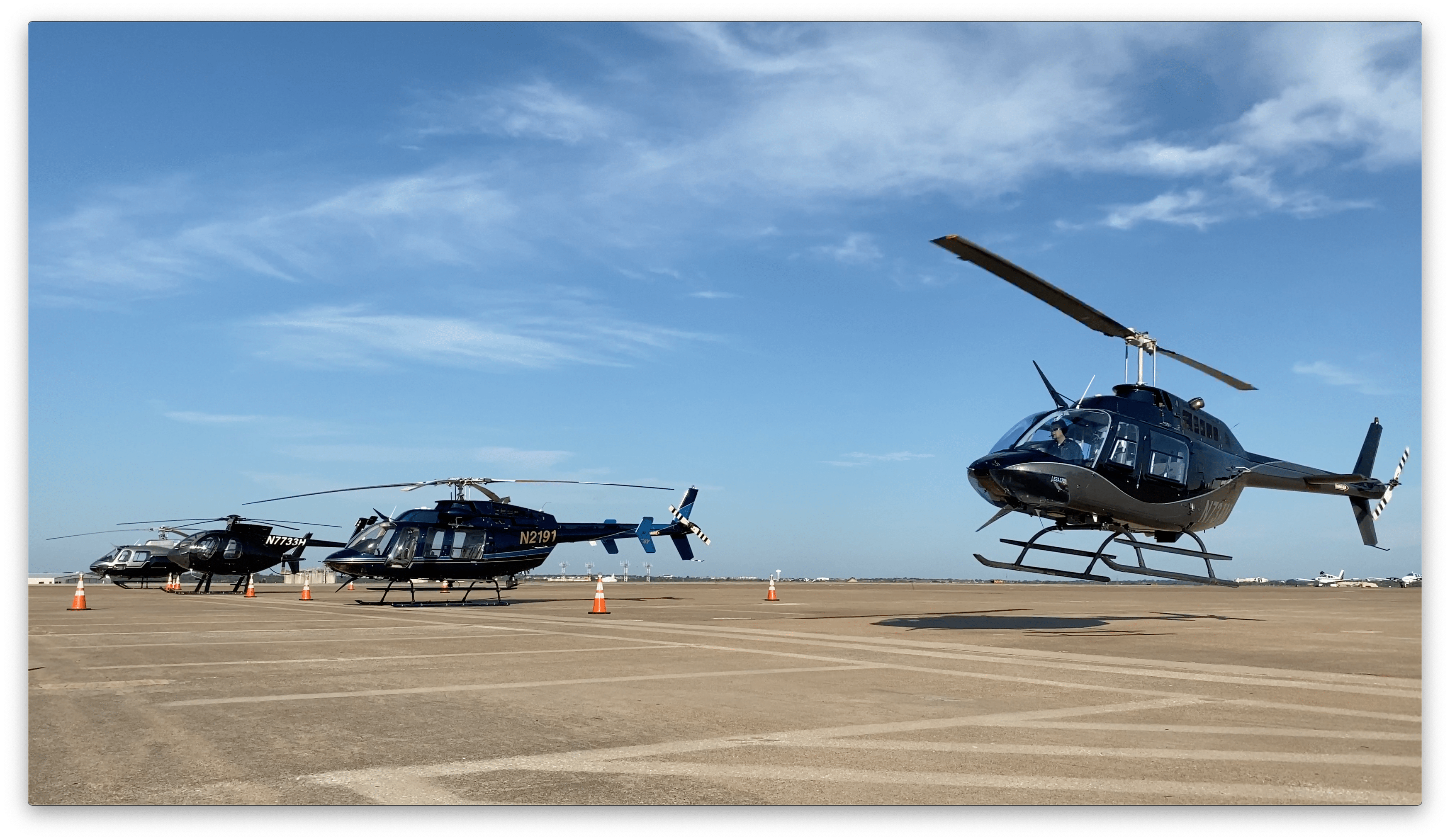 Four helicopters on runway.