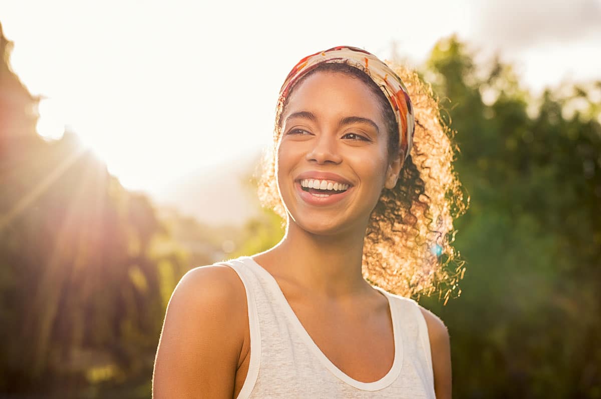 Woman smiling in sunshine.