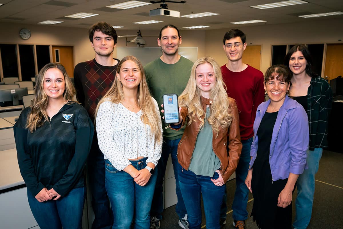 Students show off an app in a classroom