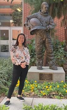 Olivia Siu poses with a statue of Neil Armstrong.