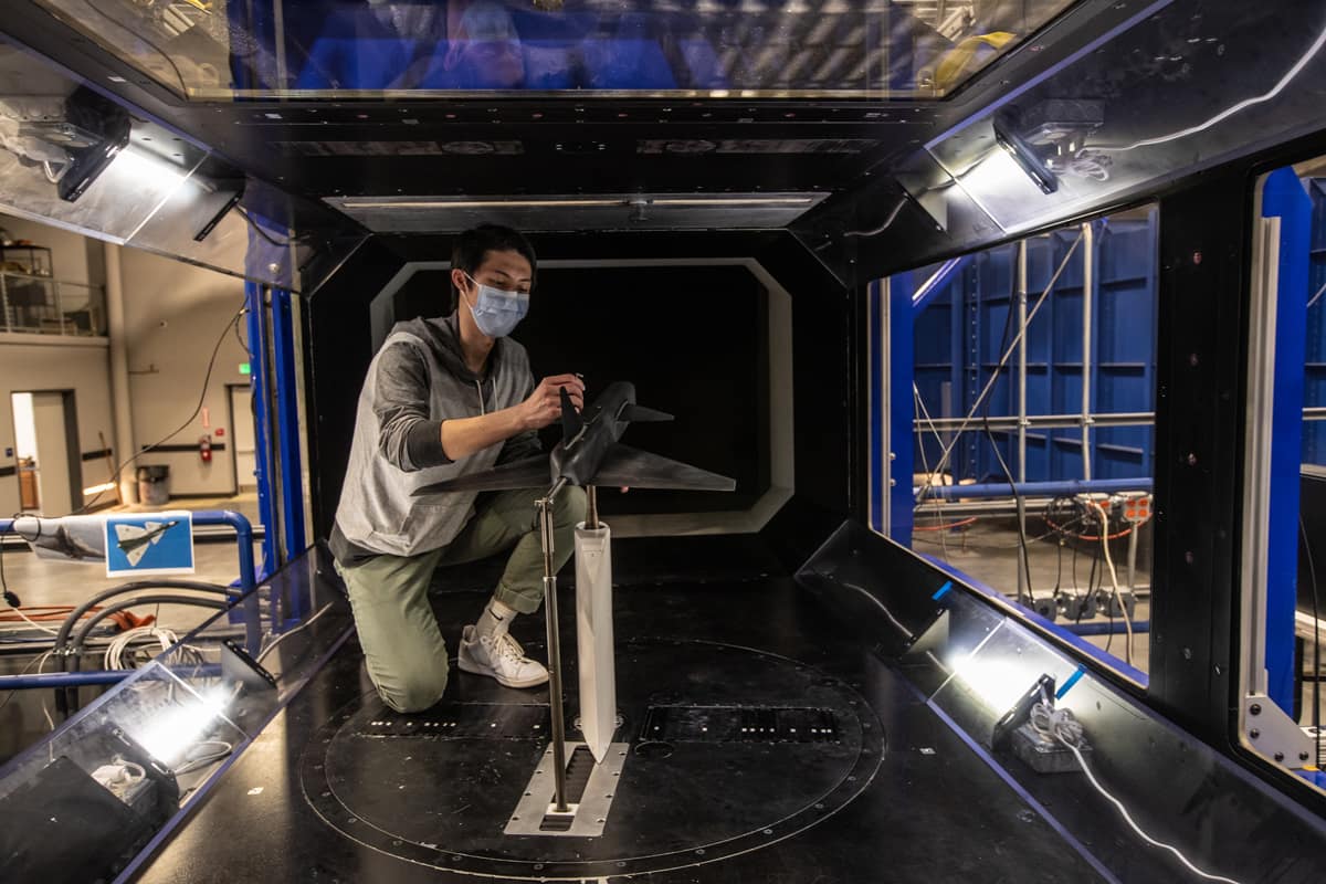 Aerospace Engineering Ph.D. student Nicholas Zhu in a wind tunnel.