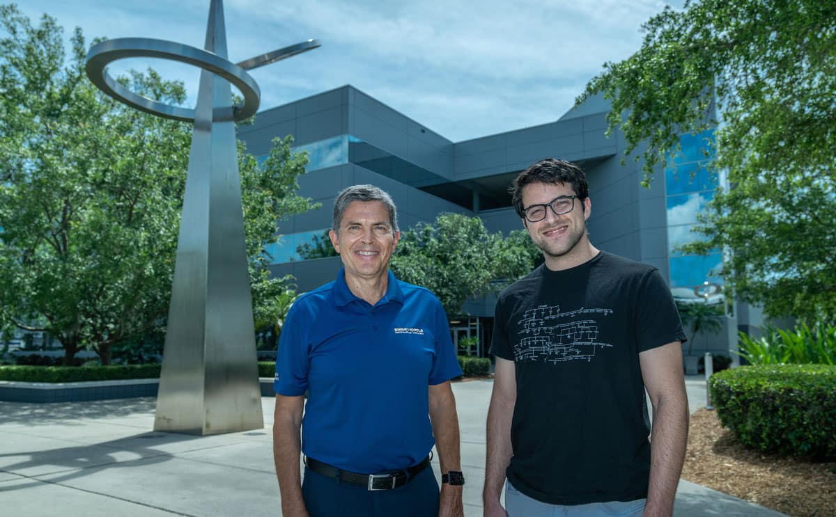 Student and professor standing outside Embry-Riddle campus.