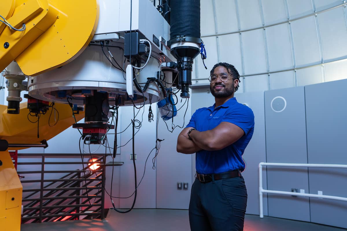 Giovanni Bacon stands in aeronautics lab.