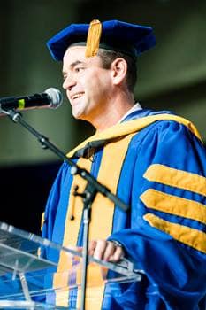 Jared Isaacman speaks at a graduation