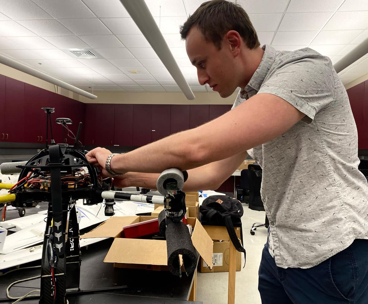 Ph.D. student John Zelina works in lab.