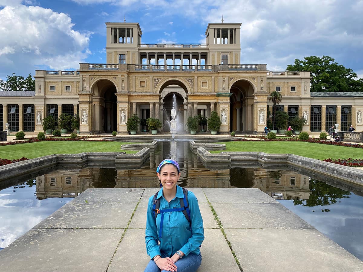 Liz Bosch sitting in front of building in Germany.