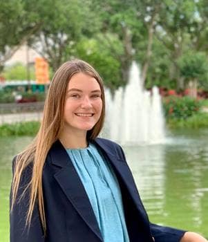 Maren Rice poses for picture in front of pond.