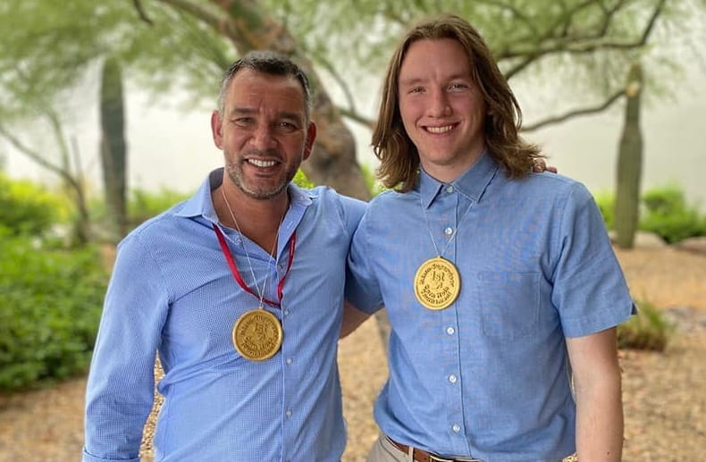 Men pose for a photo