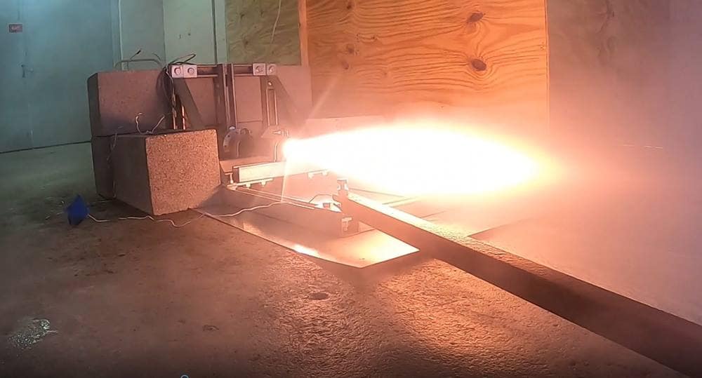 Booster firing from the back of a test motor.