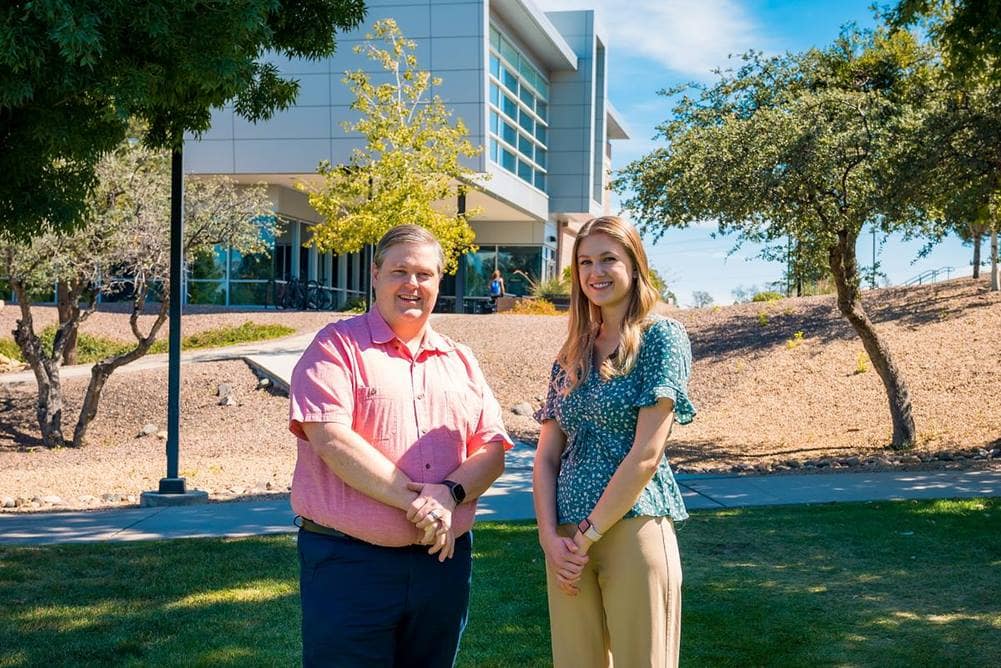 Teacher and student pose in front of Embry-Riddle Prescott Campus.