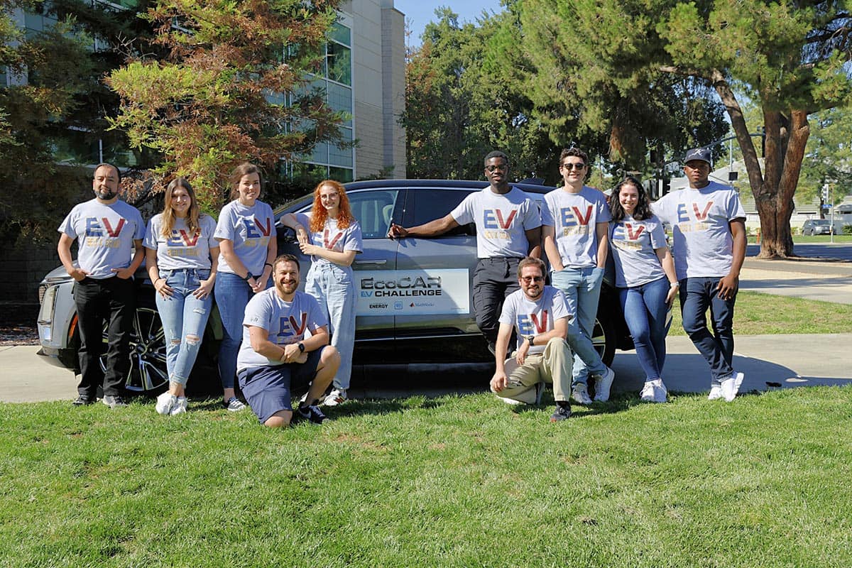 EcoCAR EV Challenge team poses around electric car.