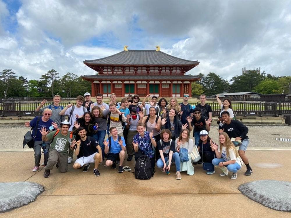 Students and teachers pose for picture in Japan.