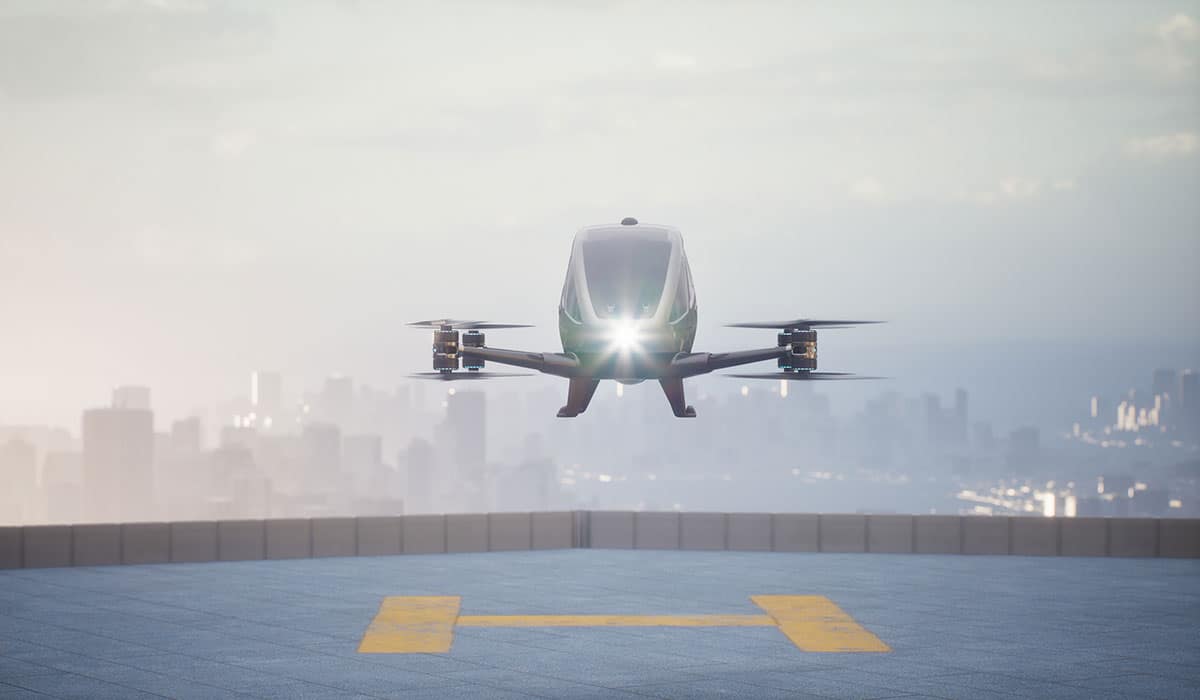 Drone hovers above landing pad.
