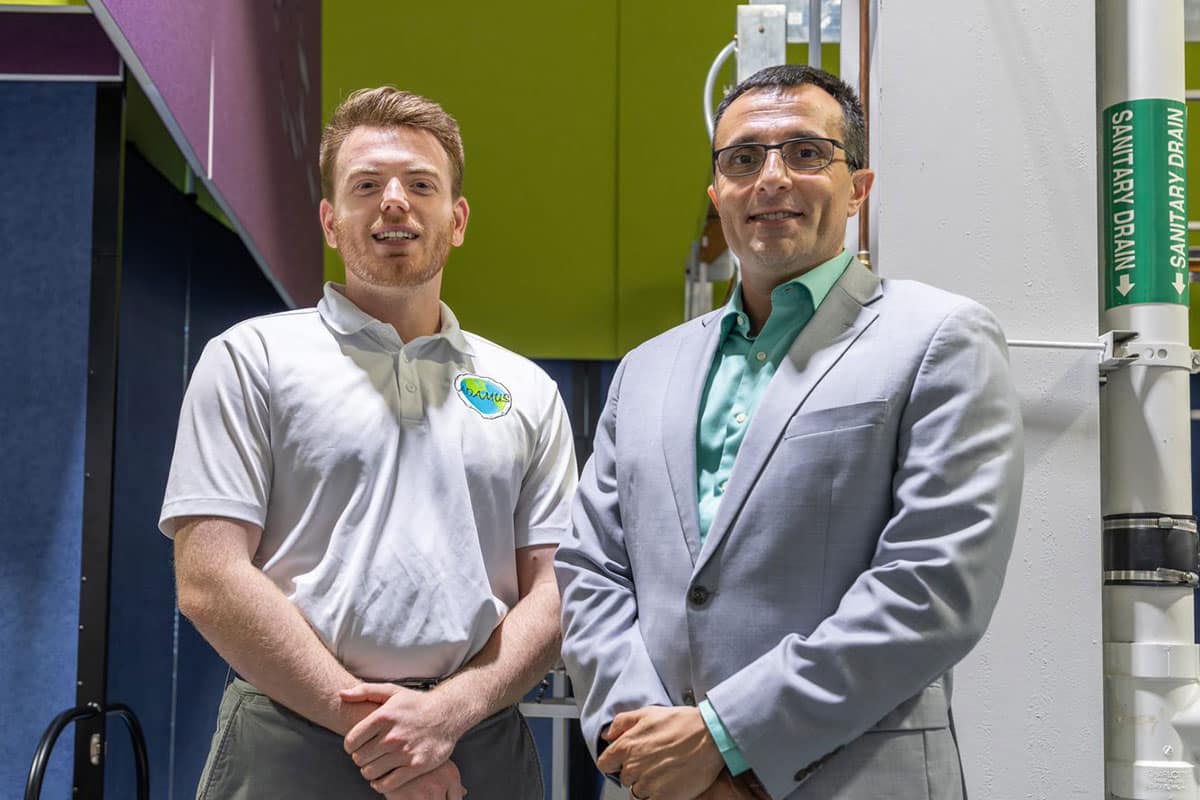 Student and teacher pose for picture in in NASA facility.