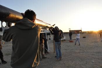 Team members carry rocket on shoulders to launch site.