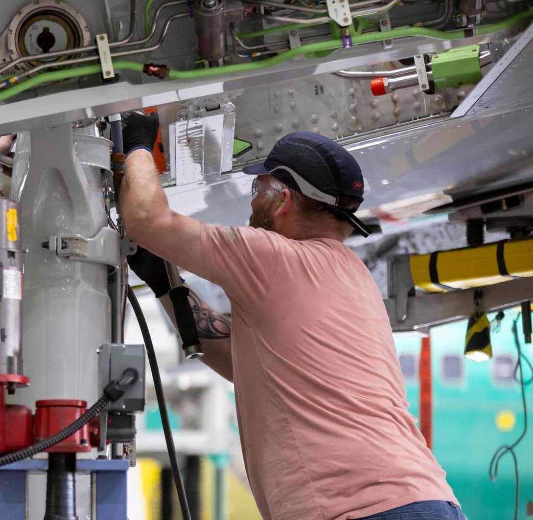 Man works on aerospace equipment.