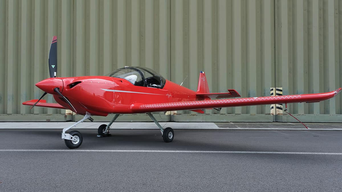 Red side-by-side two-seater airplane.