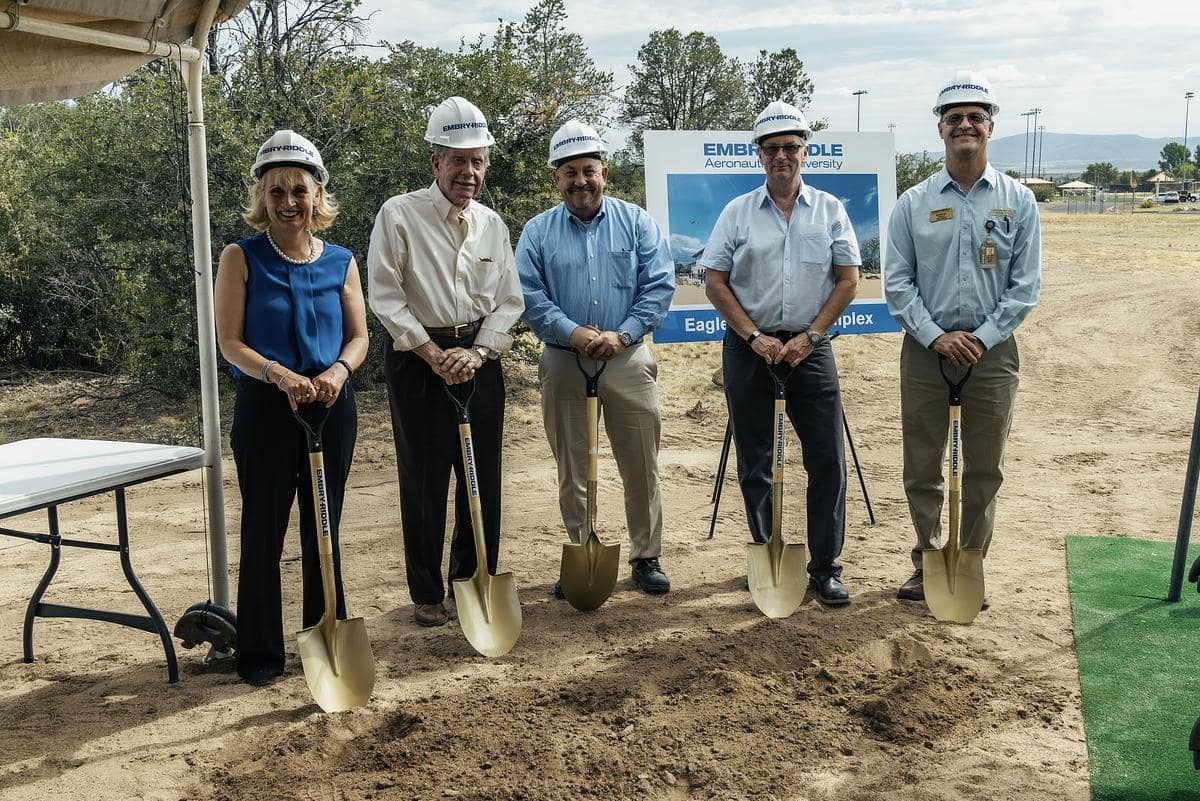 Five people holding shovels at groundbreaking ceremony.