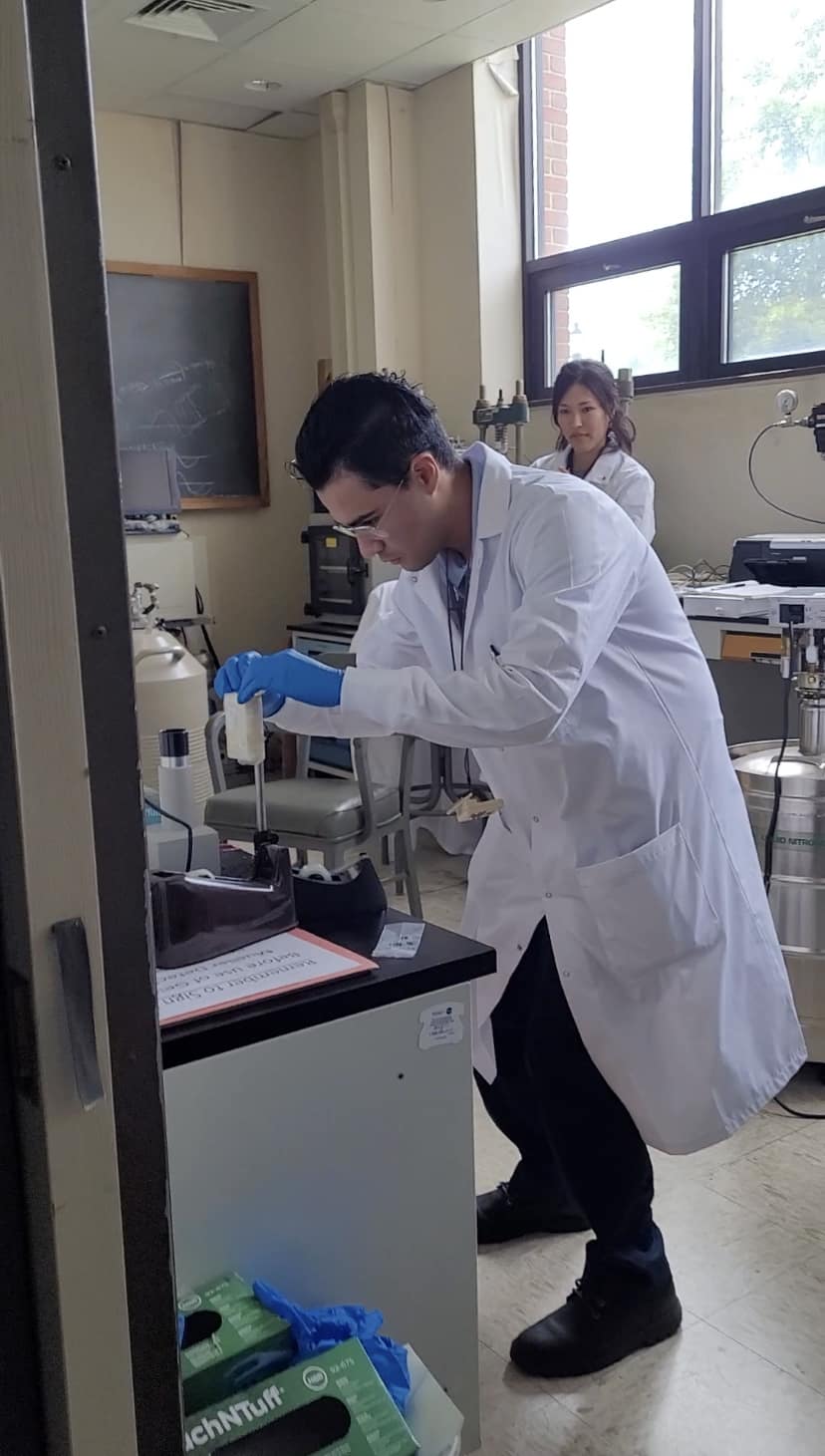 Man in lab coat works in lab.