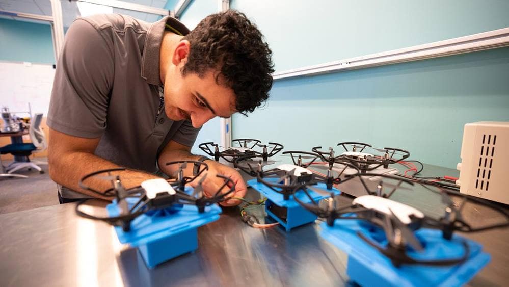 Man works on drone.